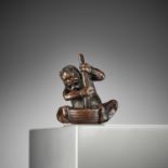 ITTAN: A FINE NAGOYA SCHOOL WOOD NETSUKE OF AN ONI WITH MORTAR AND SKULL