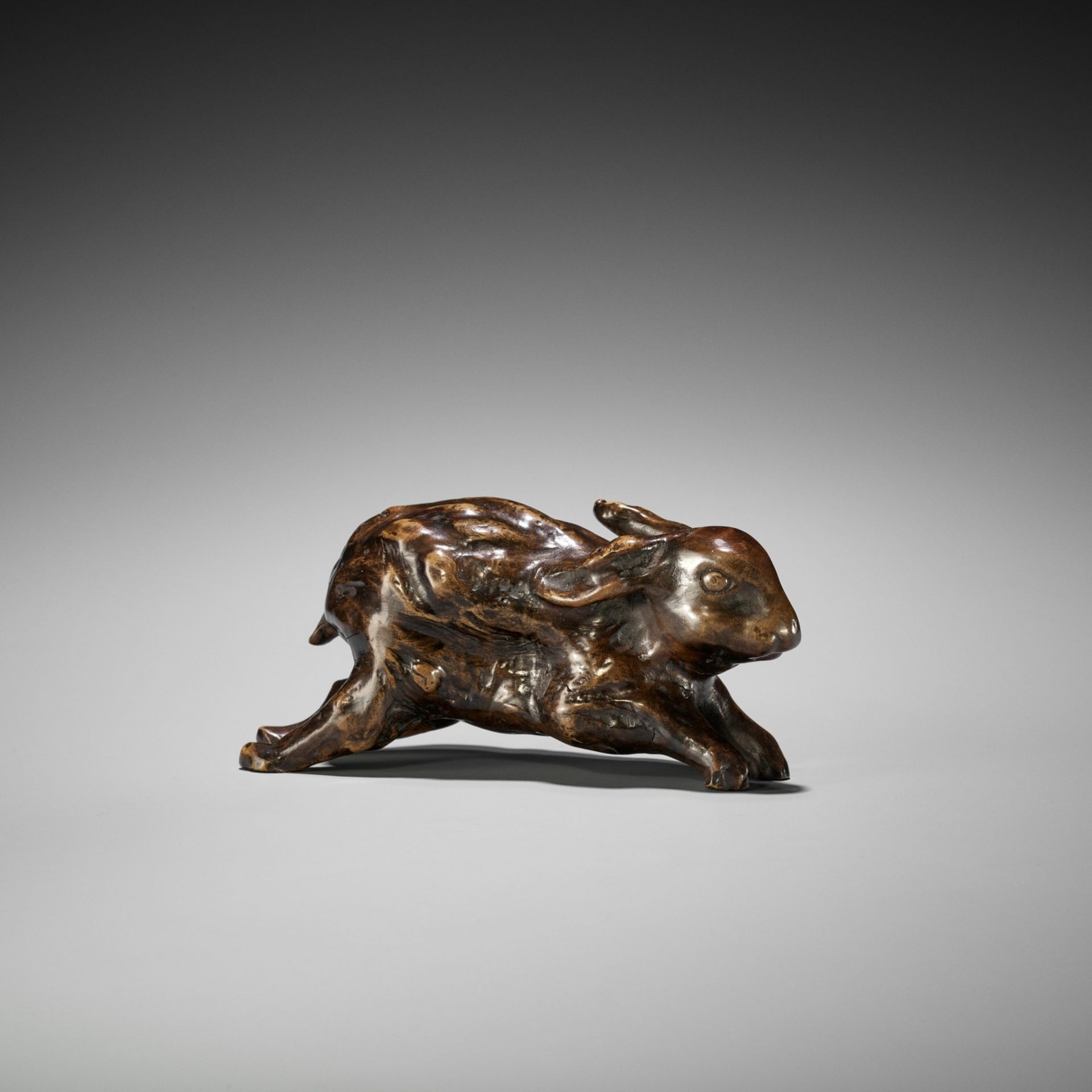 AN UNUSUAL ROOTWOOD OKIMONO OF A LEAPING HARE