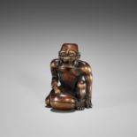 ITSUMIN: A FINE WOOD NETSUKE OF A REPENTING ONI WITH MOKUGYO