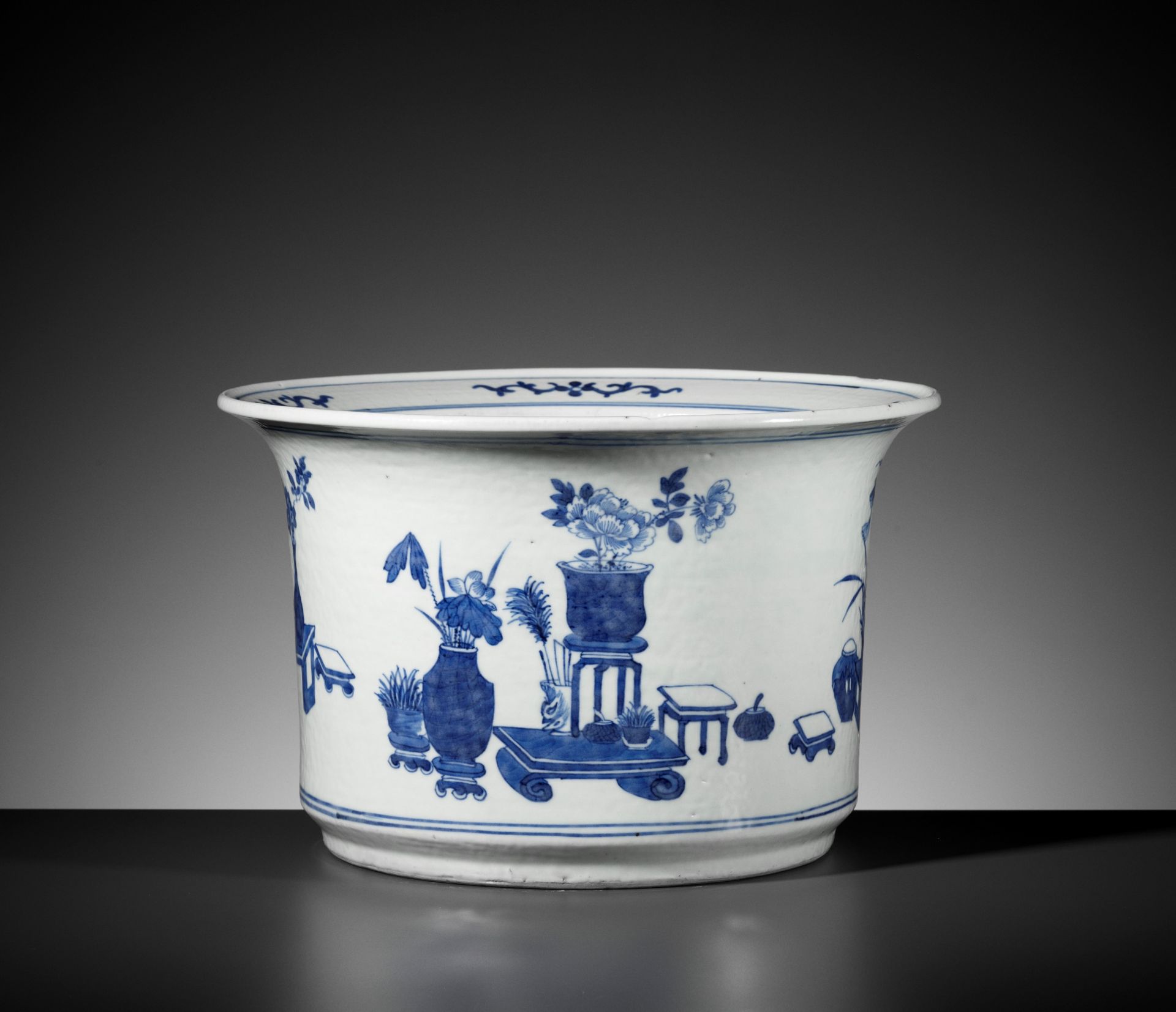 A BLUE AND WHITE 'HUNDRED TREASURES' JARDINIERE, QING DYNASTY