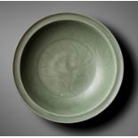A CARVED LONGQUAN CELADON 'LOTUS' CHARGER, MING DYNASTY