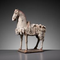 A PAINTED POTTERY FIGURE OF A CAPARISONED HORSE, EASTERN WEI DYNASTY