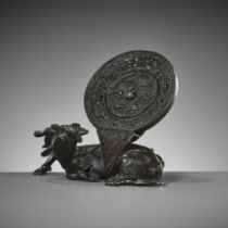 A BRONZE 'XINIU' MIRROR STAND AND 'LION AND GRAPEVINE' MIRROR, MING AND TANG DYNASTY