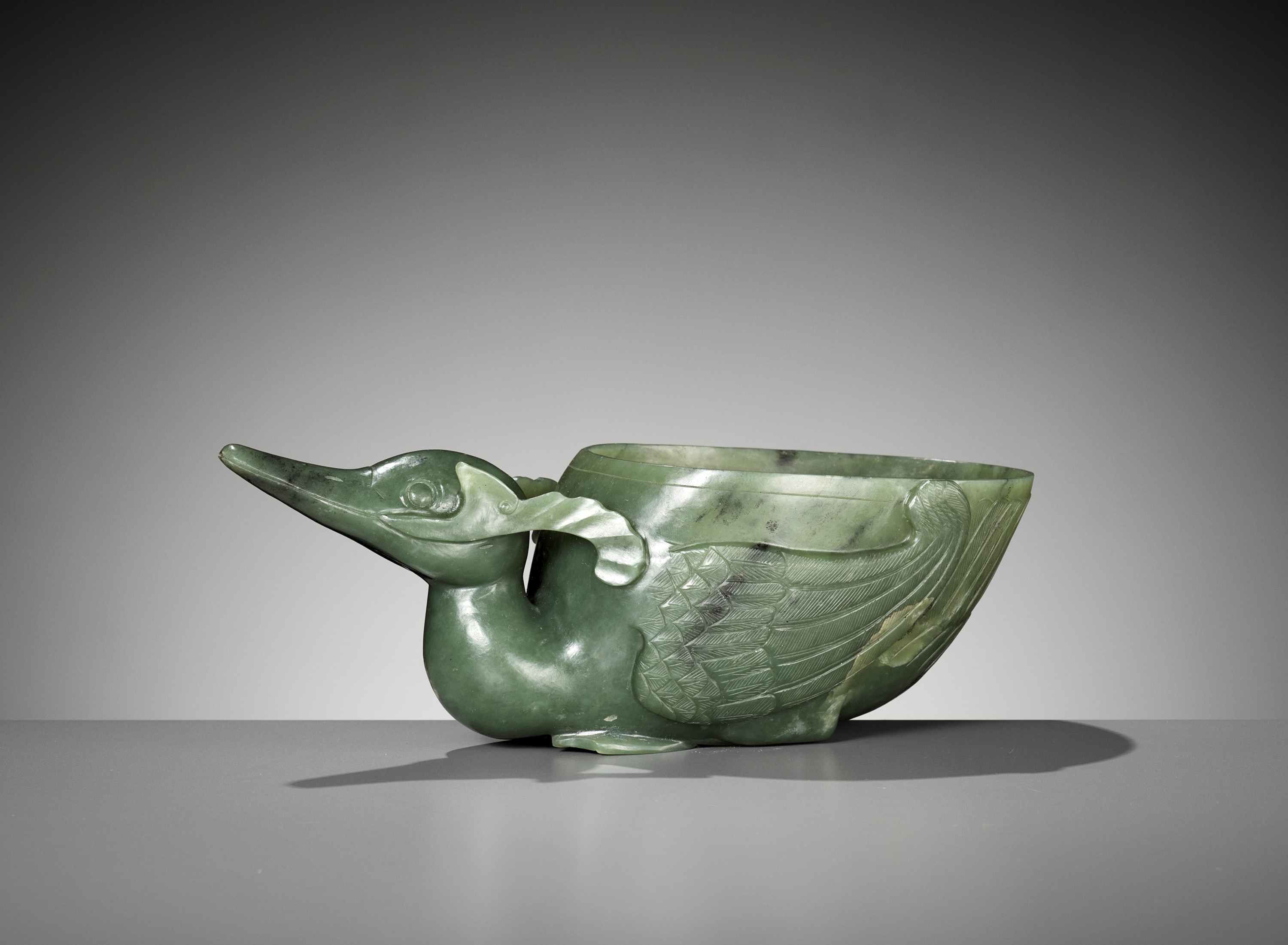 A SPINACH GREEN JADE 'DUCK' LIBATION CUP, QING DYNASTY