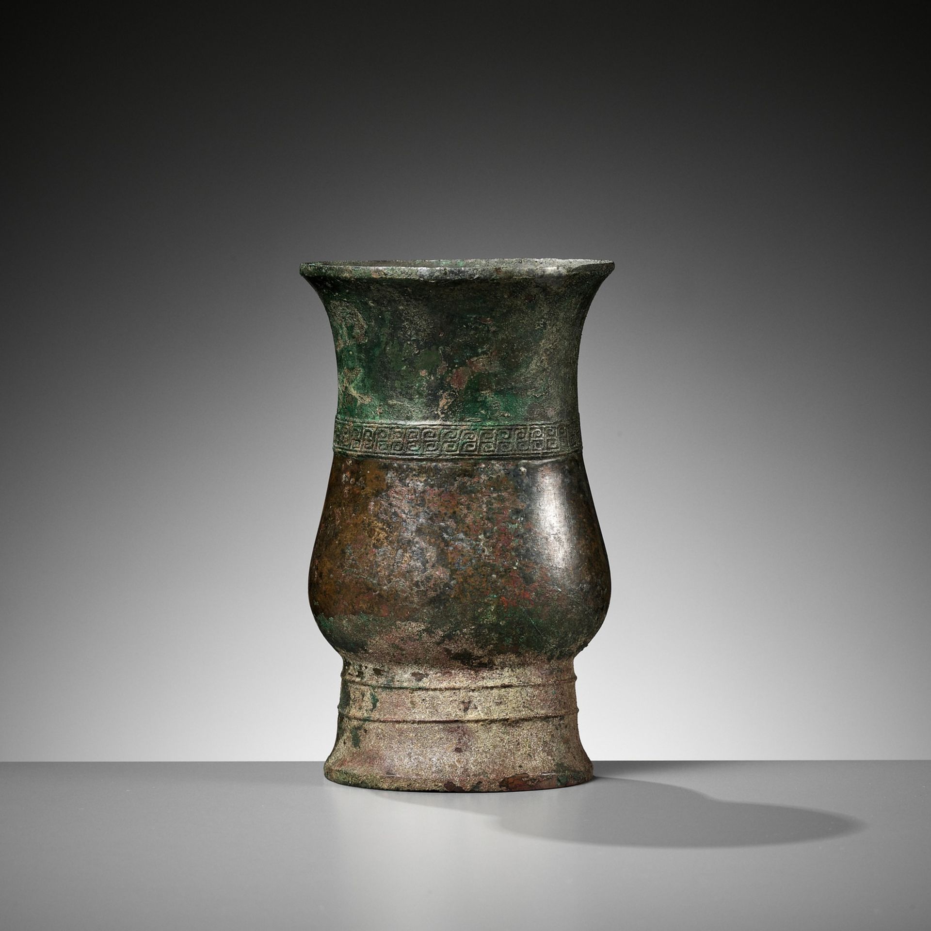 AN ARCHAIC BRONZE RITUAL WINE VESSEL, ZHI, LATE SHANG TO EARLY WESTERN ZHOU DYNASTY