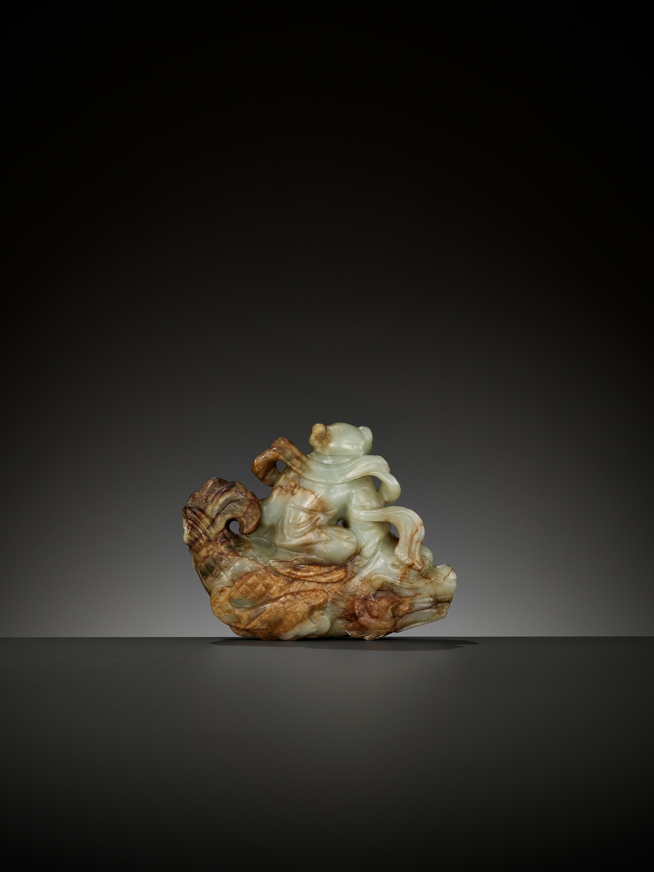 A CELADON AND RUSSET JADE FIGURE OF A BOY RIDING A DRAGON-CARP, 17TH-18TH CENTURY - Image 2 of 13