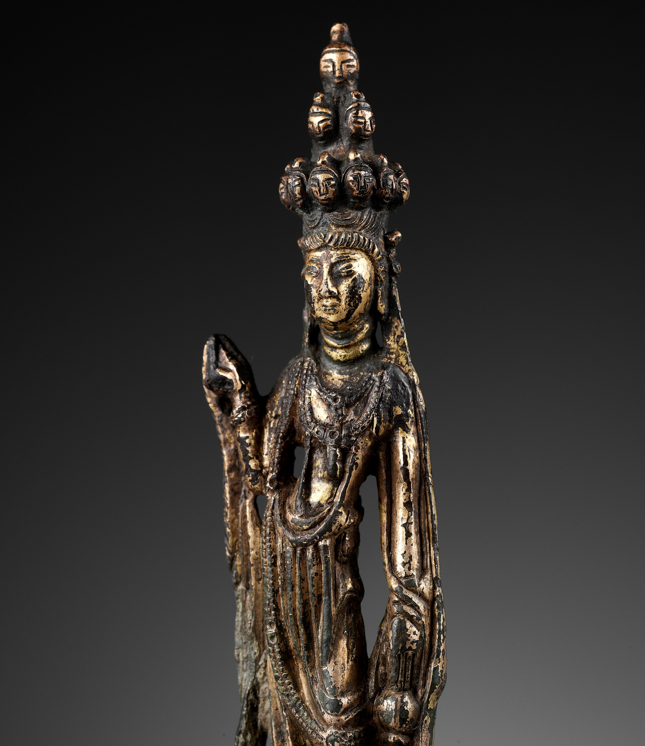 A GILT BRONZE FIGURE OF THE ELEVEN-HEADED AVALOKITESHVARA, TANG DYNASTY