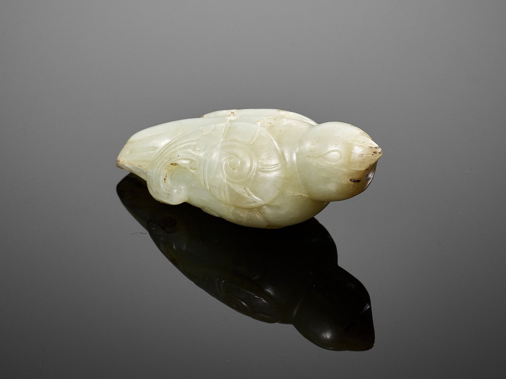 A CELADON JADE 'BIRD' PENDANT, SONG DYNASTY