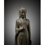 A SANDSTONE FIGURE OF STANDING BUDDHA