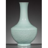 A CARVED CELADON-GLAZED 'LOTUS' VASE, QIANLONG MARK AND PERIOD