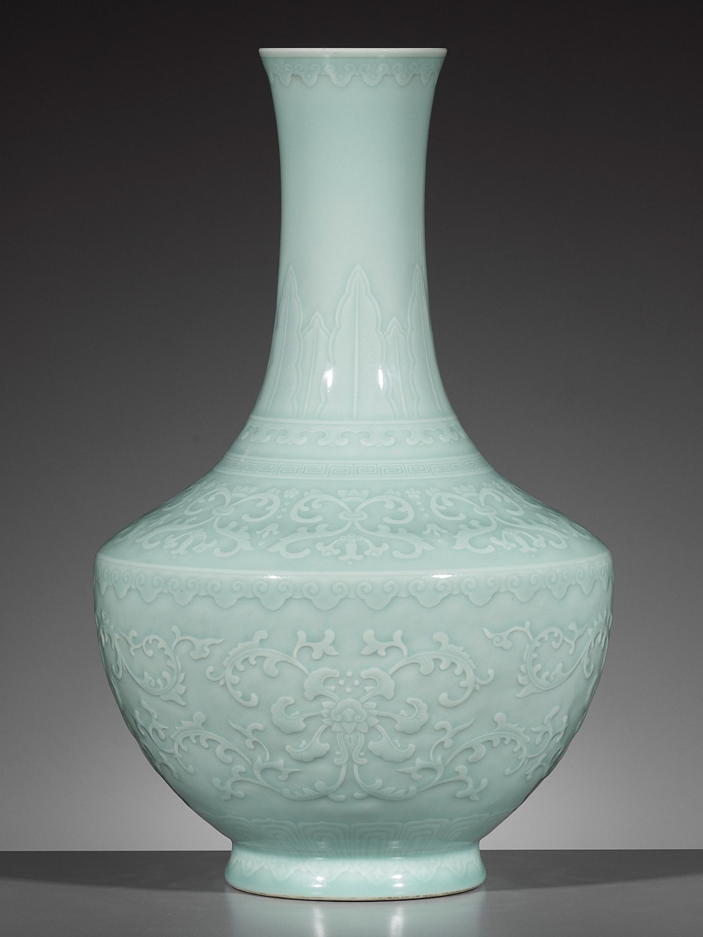 A CARVED CELADON-GLAZED 'LOTUS' VASE, QIANLONG MARK AND PERIOD