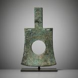 A RARE AND IMPORTANT BRONZE RITUAL AXE-HEAD, YUE, EARLY SHANG DYNASTY, CIRCA 1500-1400 BC