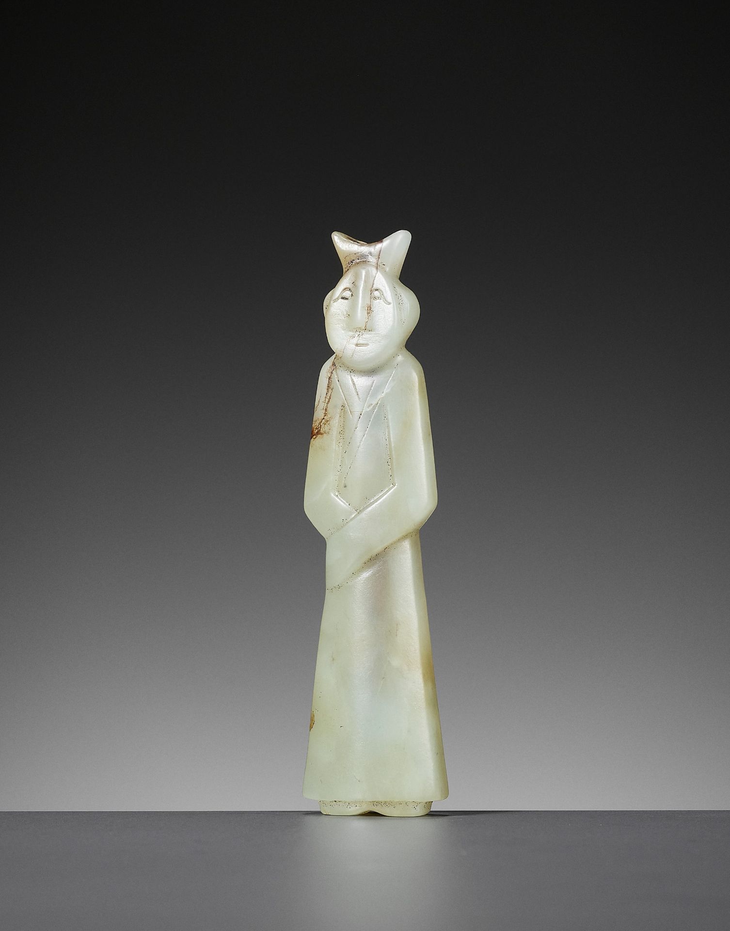 A CELADON JADE 'FIGURE' PENDANT, HAN DYNASTY