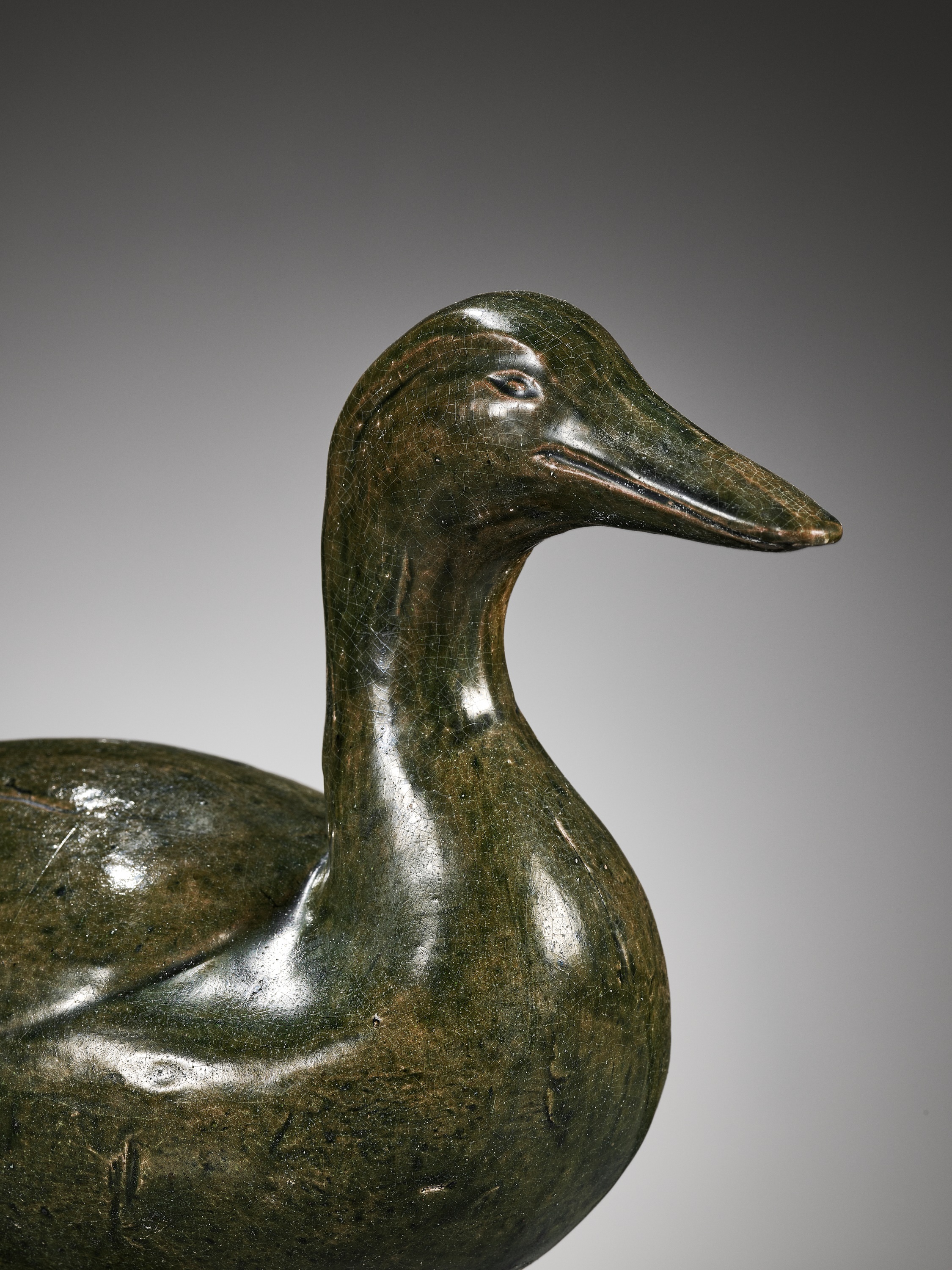 A GREEN GLAZED POTTERY FIGURE OF A DUCK, HAN DYNASTY