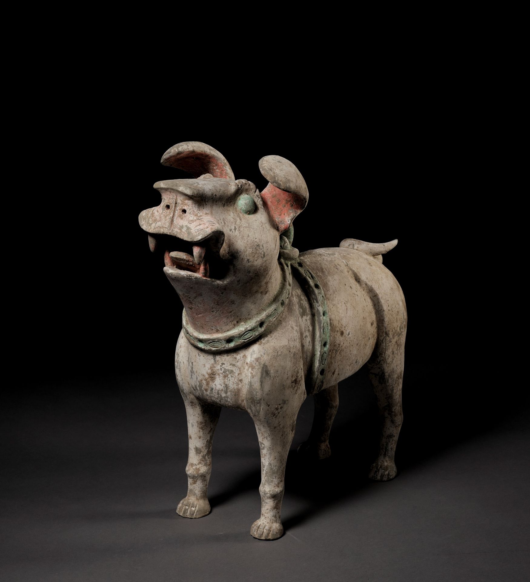 A MASSIVE PAINTED POTTERY FIGURE OF A GUARDIAN DOG, LATE EASTERN HAN TO SIX DYNASTIES