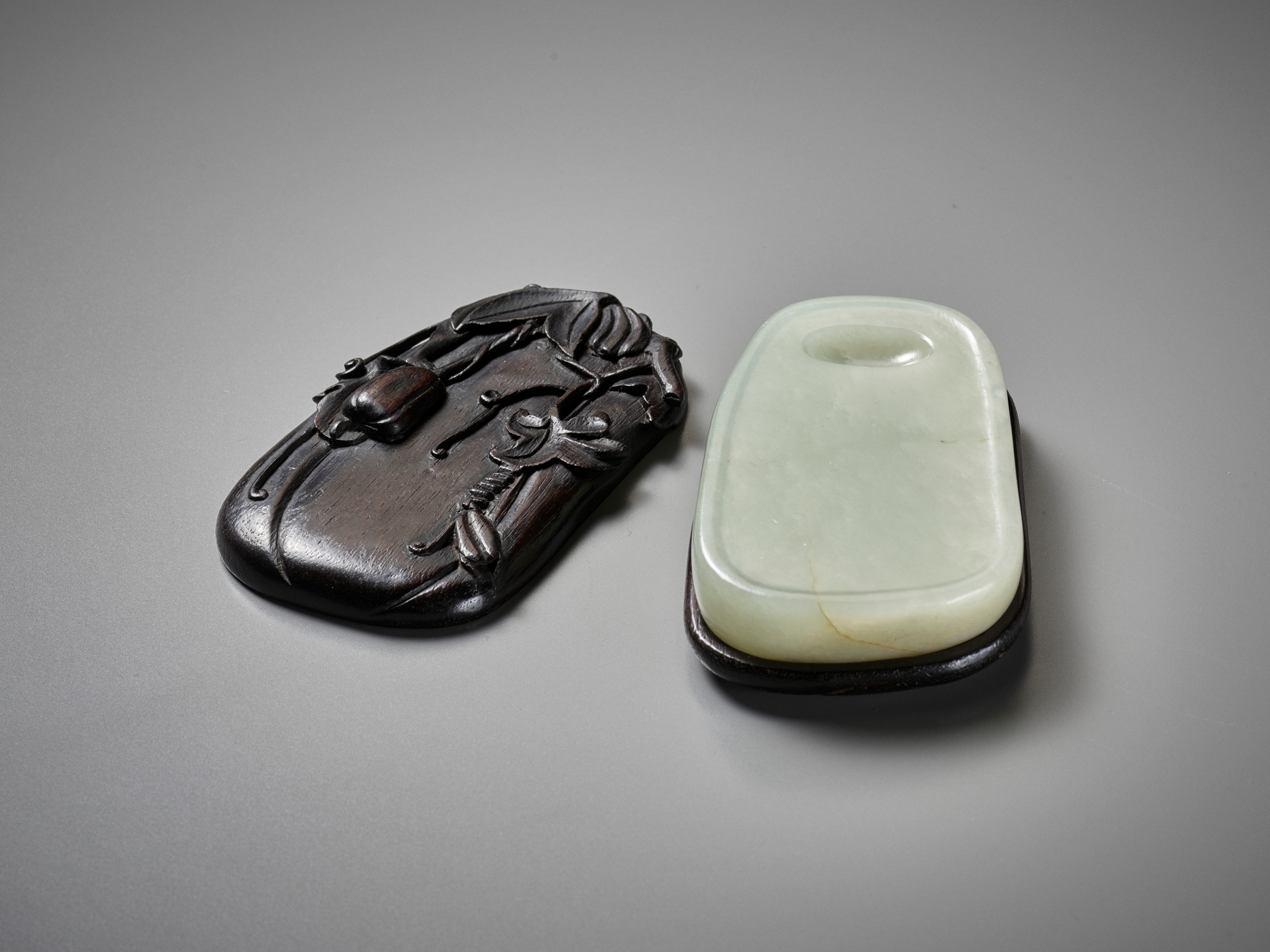 A PALE CELADON JADE INKSTONE WITH MATCHING ZITAN STAND AND COVER, QING DYNASTY