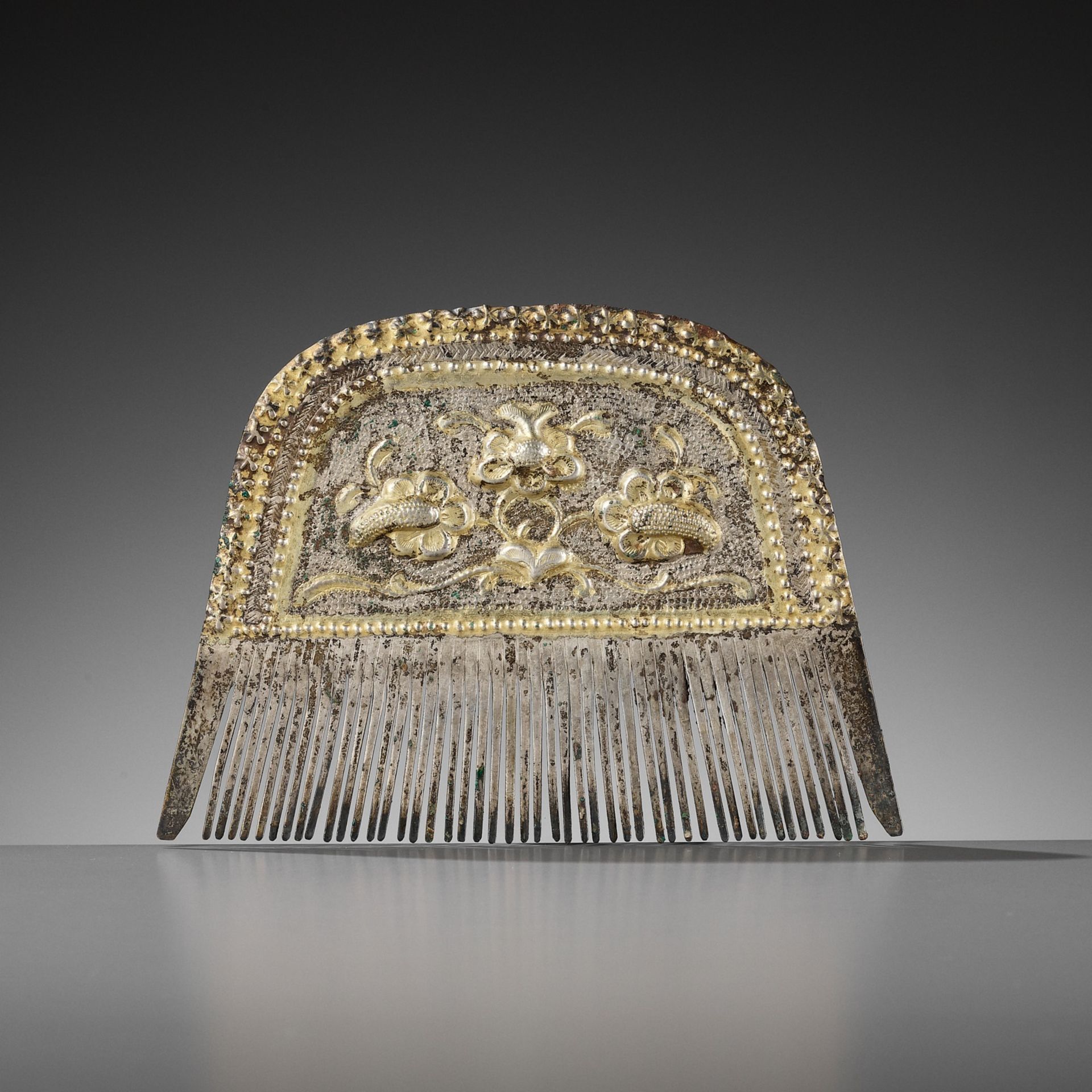 A PARCEL-GILT SILVER COMB, TANG DYNASTY