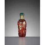 A RUBY-RED OVERLAY GLASS 'DRAGON CARP' SNUFF BOTTLE, QING DYNASTY
