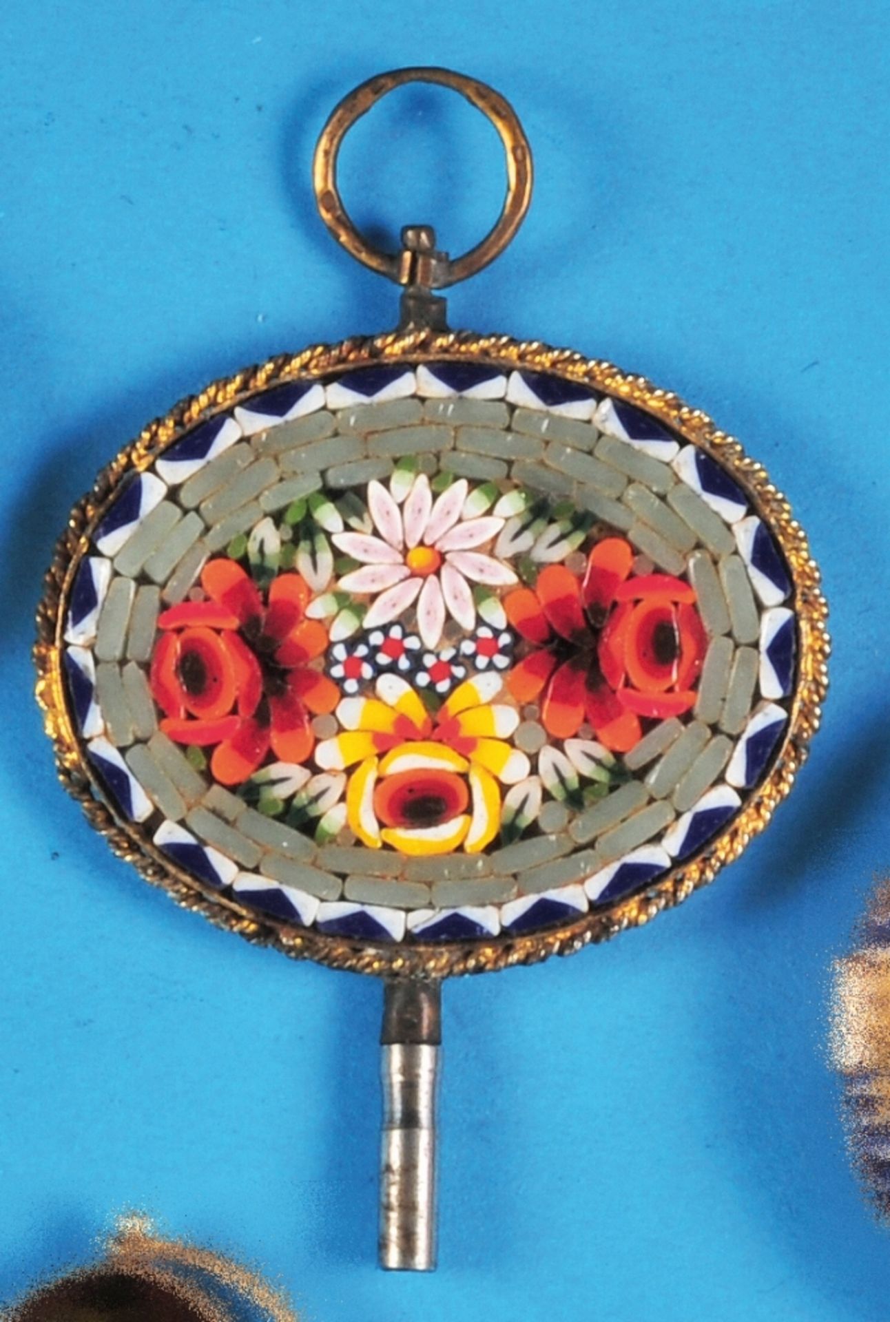 Mosaic pocket watch key in gilt setting, oval plate with colourful mosaic with floral decoration, It