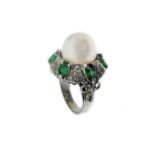 White gold ring with pearl, brilliants and emeralds.