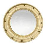 Circular wooden mirror lacquered in ivory tones. Golden details and convex mirror, in the style of t