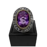 Low grade ring with central faceted amethyst with diamond crown