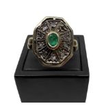 Octagonal shaped ring in Low grade 12 carat gold with central emerald and diamonds