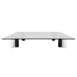 Low square table with support feet formed by cylindrical geometric elements in marble.