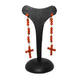 Low title gold and coral pendant earrings, with final cross