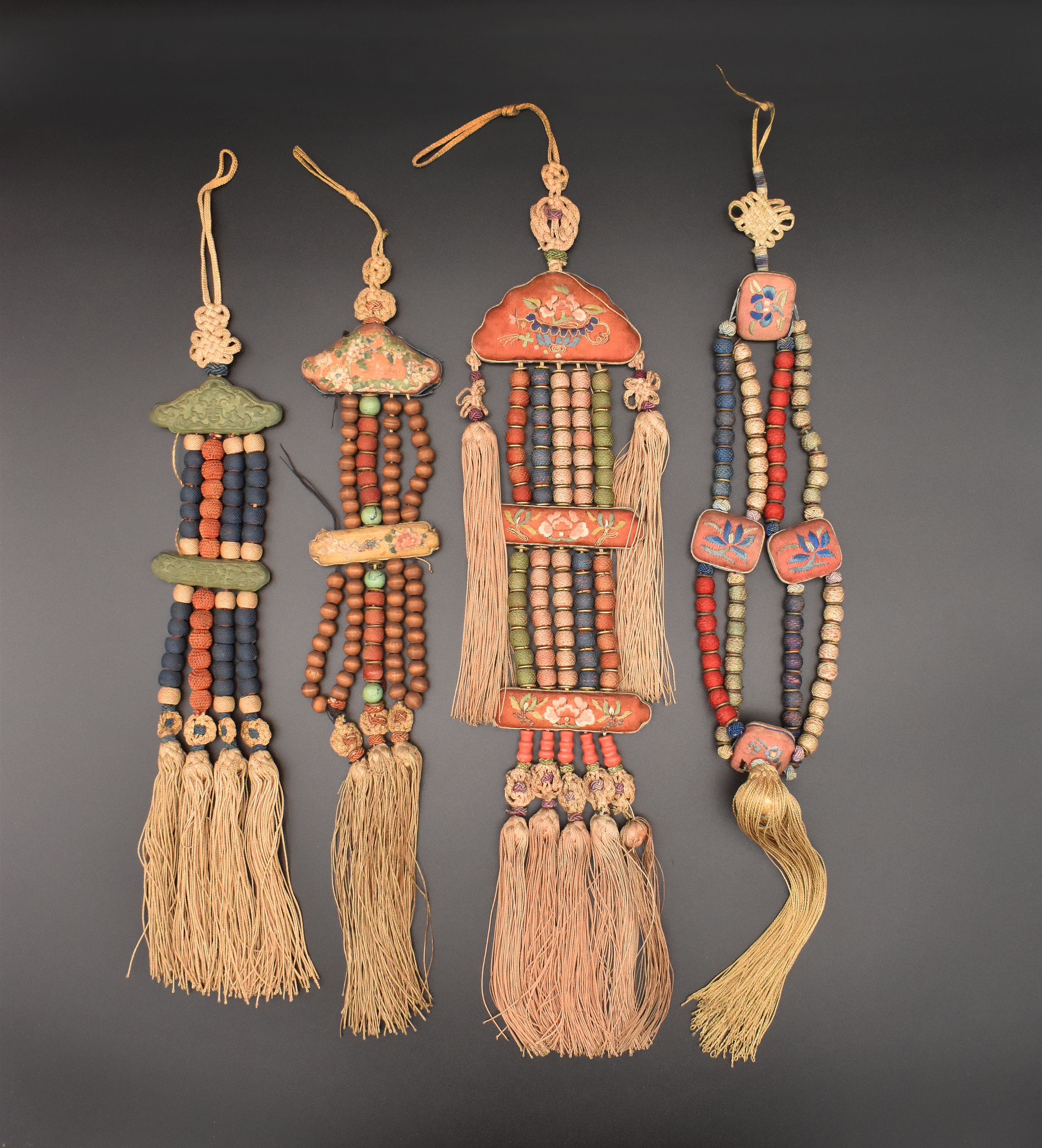 A GROUP OF FOUR CHINESE SILK HANGING CHARMS, QING DYNASTY, LATE 19TH/EARLY 20TH CENTURY