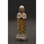 A CHINESE GILT-LACQUER BRONZE FIGURE OF A LUOHAN, LATE MING DYNASTY, 16TH/17TH CENTURY