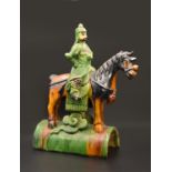 A CHINESE SANCAI-GLAZED POTTERY FIGURE OF A WARRIOR ON HORSEBACK, LATE MING, 16TH/17TH CENTURY