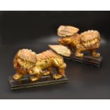 A PAIR OF CHINESE GILTWOOD LION DOGS, QING DYNASTY, EARLY 19TH CENTURY