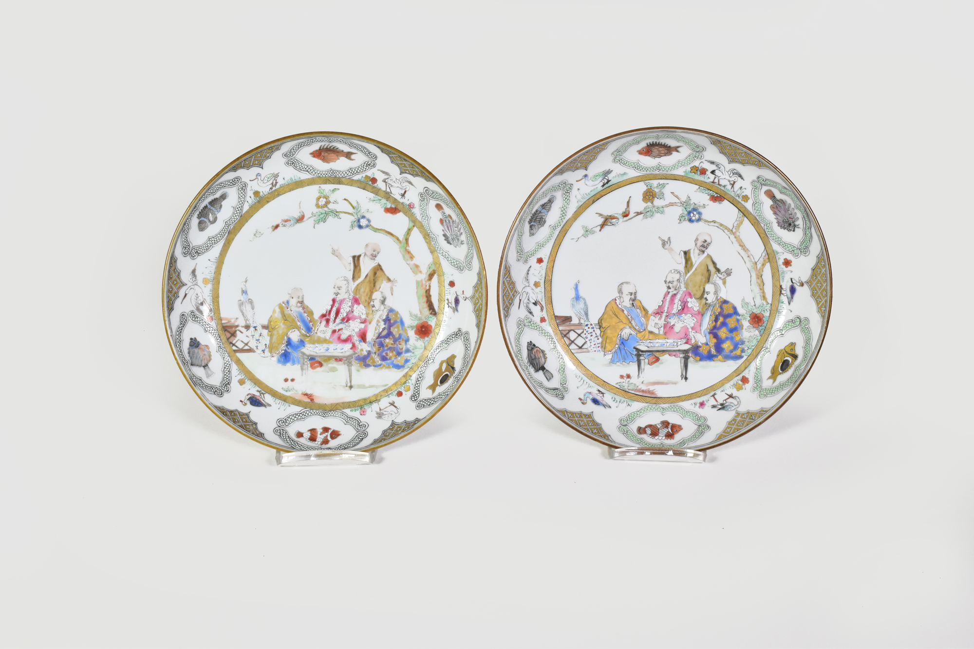 A PAIR OF CHINESE EXPORT ‘FAMILLE ROSE’ ‘PRONK DOCTOR’S VISIT' SAUCER DISHES, QIANLONG, CIRCA 1740