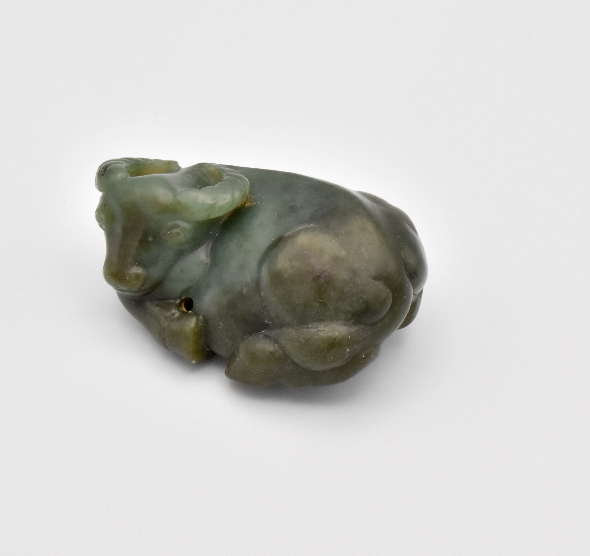 A CHINESE GREEN JADE CARVING OF A RECUMBENT WATER BUFFALO, QING DYNASTY