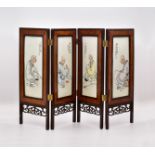 FOUR CHINESE ENAMELLED PORCELAIN ‘BUDDHIST’ PANELS, MOUNTED AS A TABLE SCREEN, 20TH CENTURY