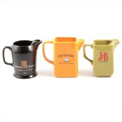 Twenty-one ceramic water jugs, whisky branded, and other whisky branded ceramics and glassware