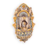 Acquasantiera in maiolica decorata con elementi in rilievo e l'effigie di Sant'Antonio da Padova.