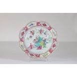 Porcelain plate from the 18th century famille rose beautiful decoration of a character holding the