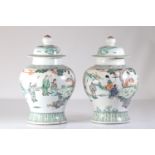 Pair of Qing dynasty famille verte covered vases decorated with figures