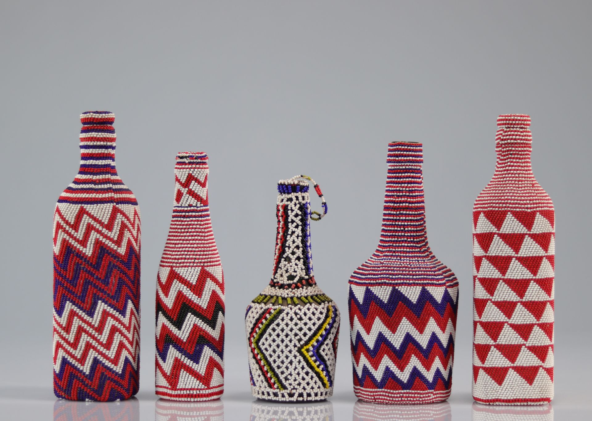 Set of beaded bottles with geometric patterns