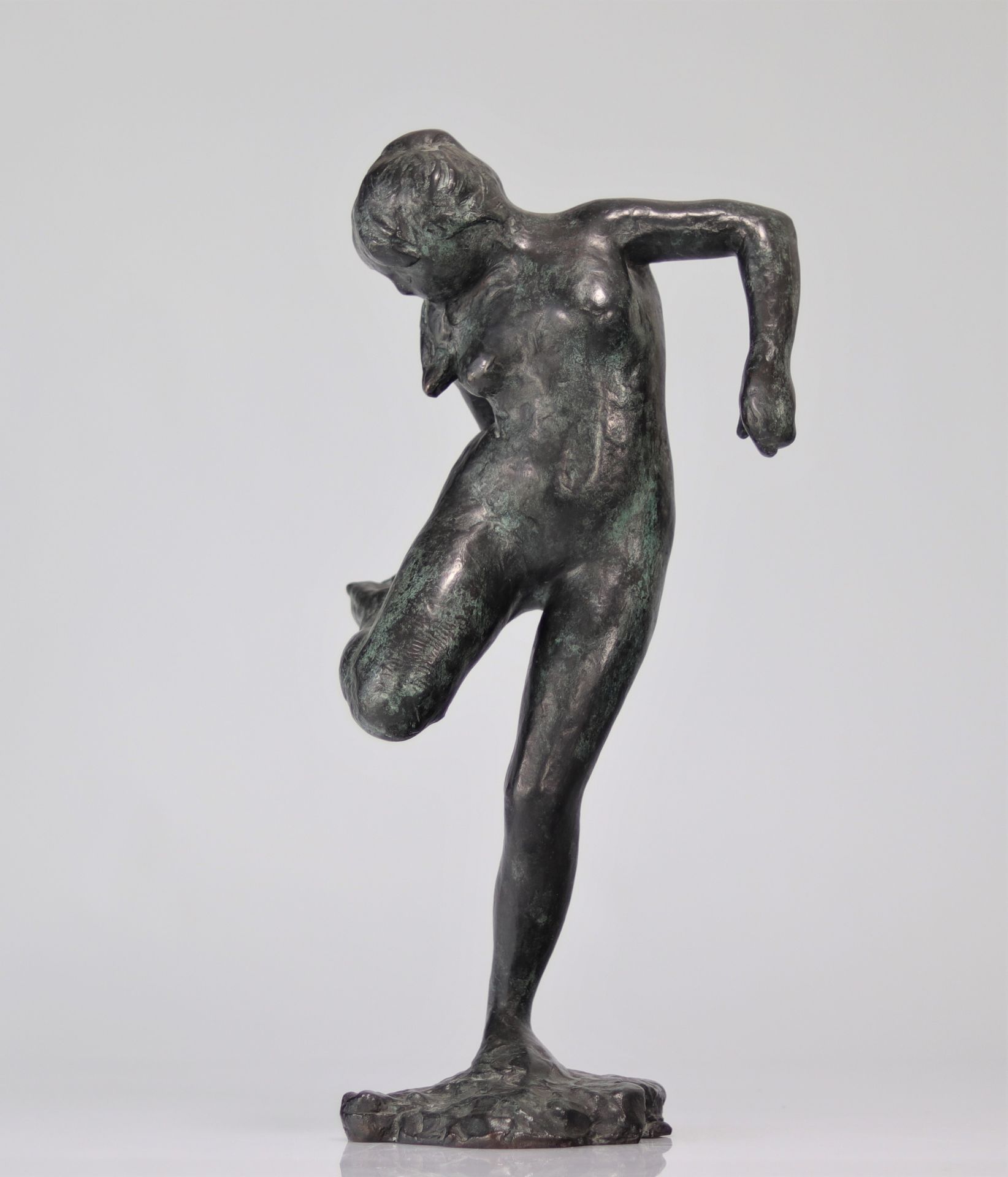 Edgar Degas. â€œDancer looking at the sole of her right footâ€. Bronze with nuanced green patina. S