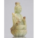 Guanyin in celadon green jade seated on a Qing period lotus flower