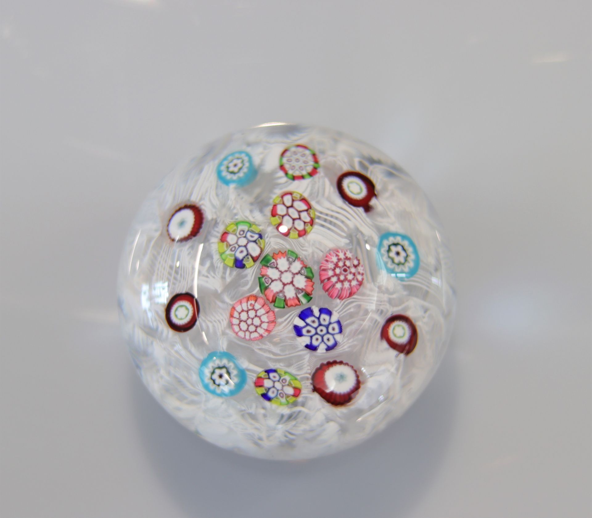 Baccarat paperweight with floral decoration on a 19th century lace background