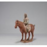 CHINA - TANG period (618-907) Rider on horseback at a standstill Terracotta with traces of white sli