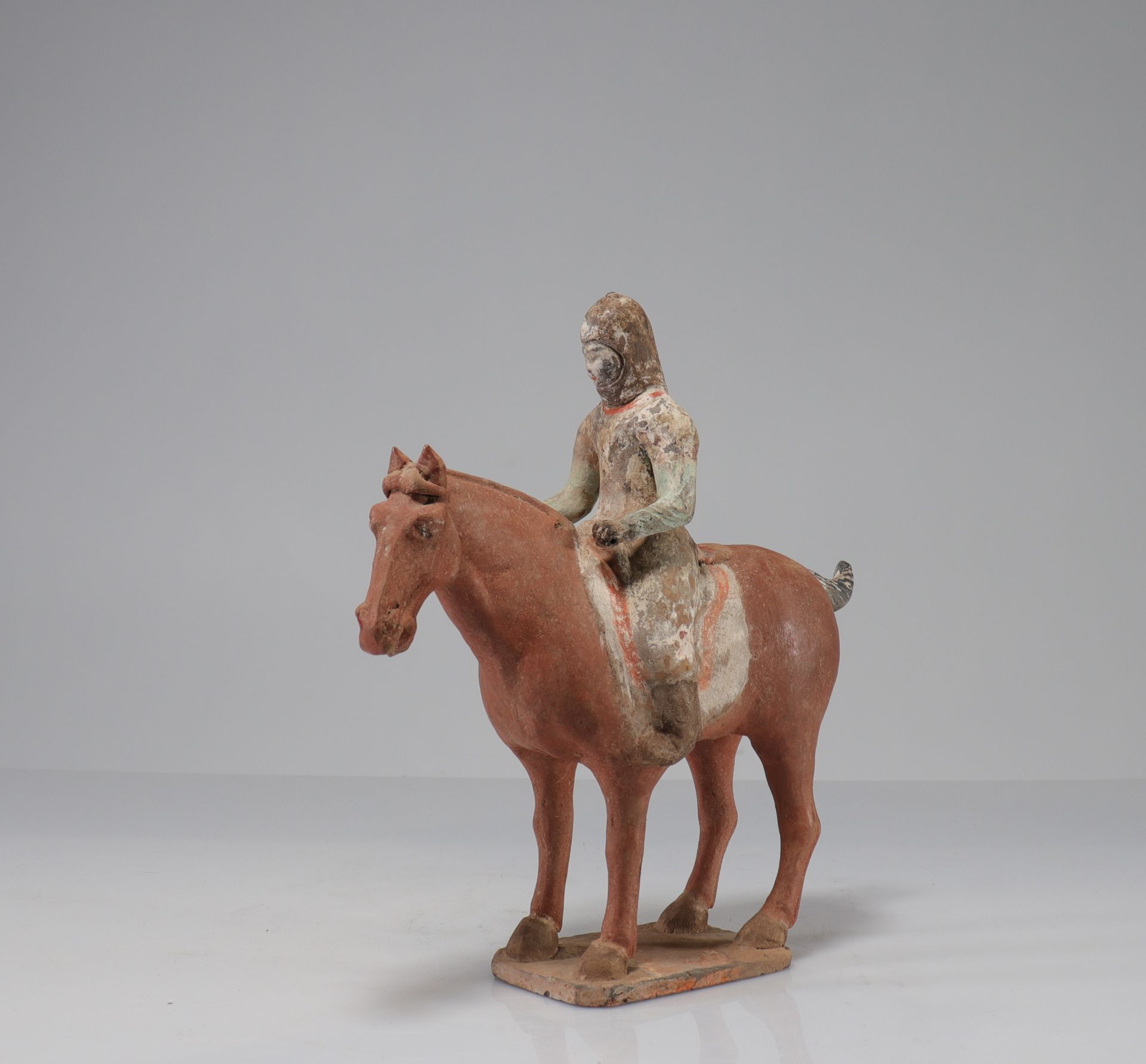 CHINA - TANG period (618-907) Rider on horseback at a standstill Terracotta with traces of white sli