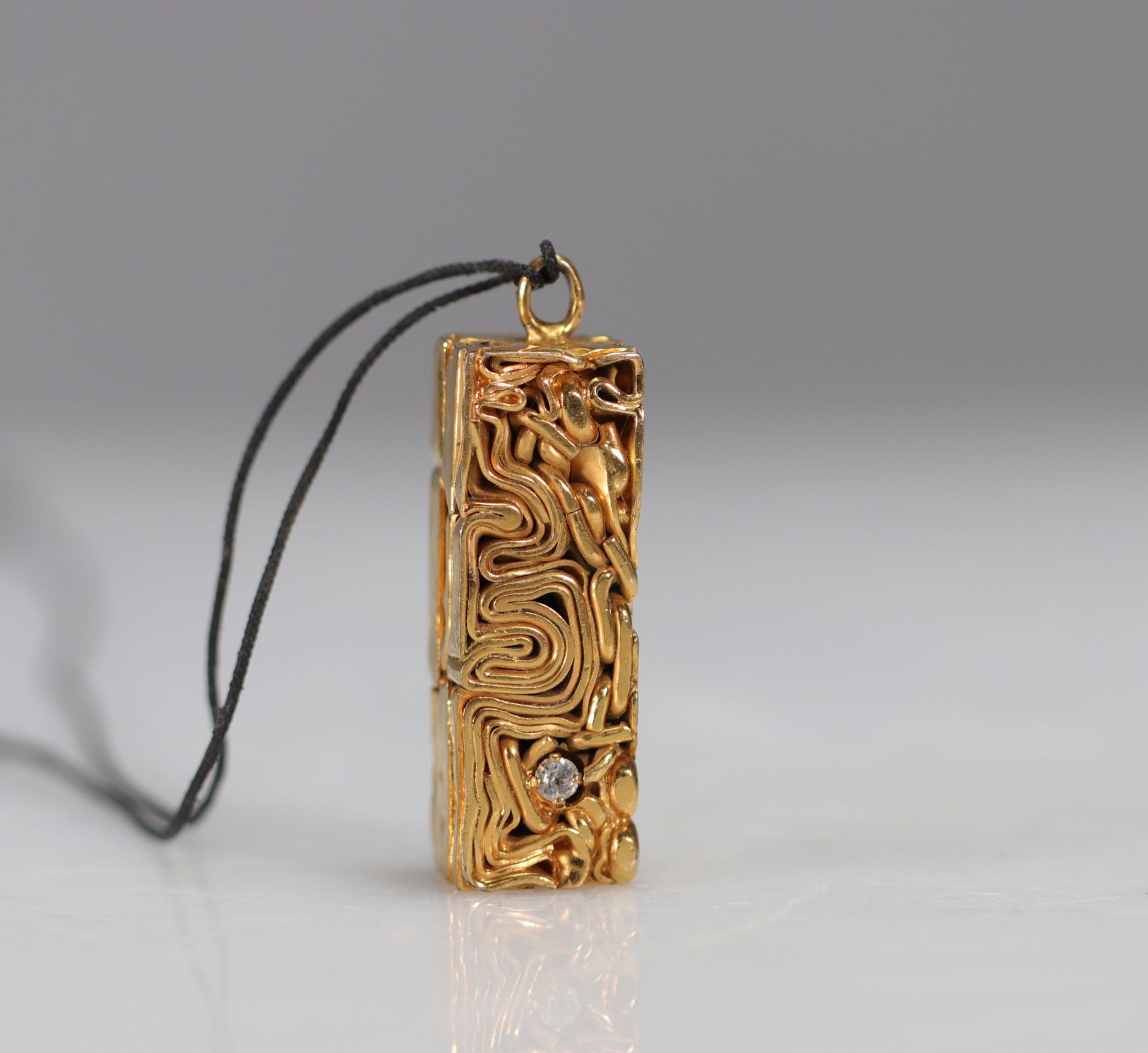 Caesar Baldaccini. Compression. Pendant made of gilded metal jewelry and compressed ceremonial stone