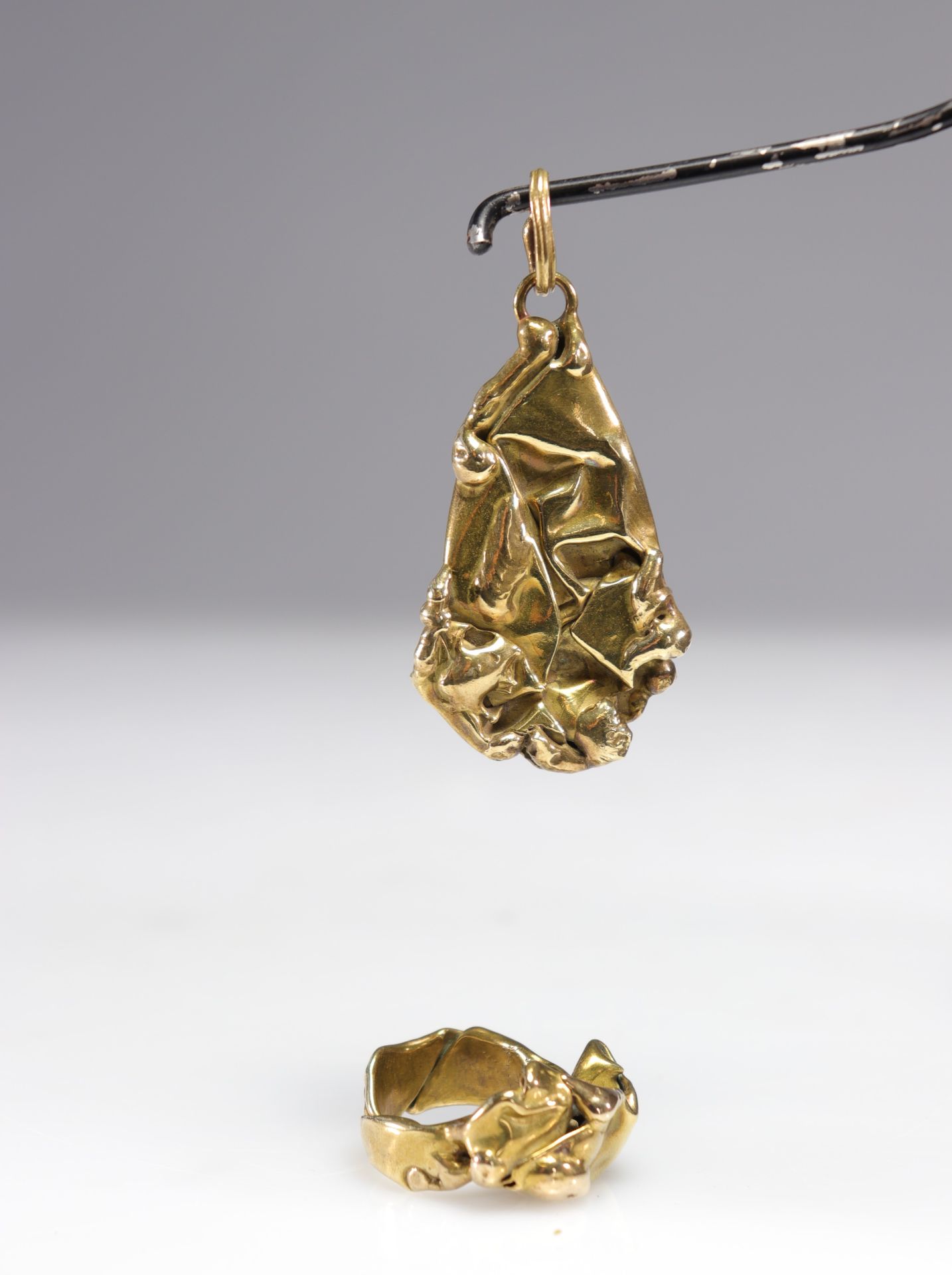 Cesar Baldaccini (Attr). Cuts. Jewelry set comprising a pendant and a brass ring, compressed and wel