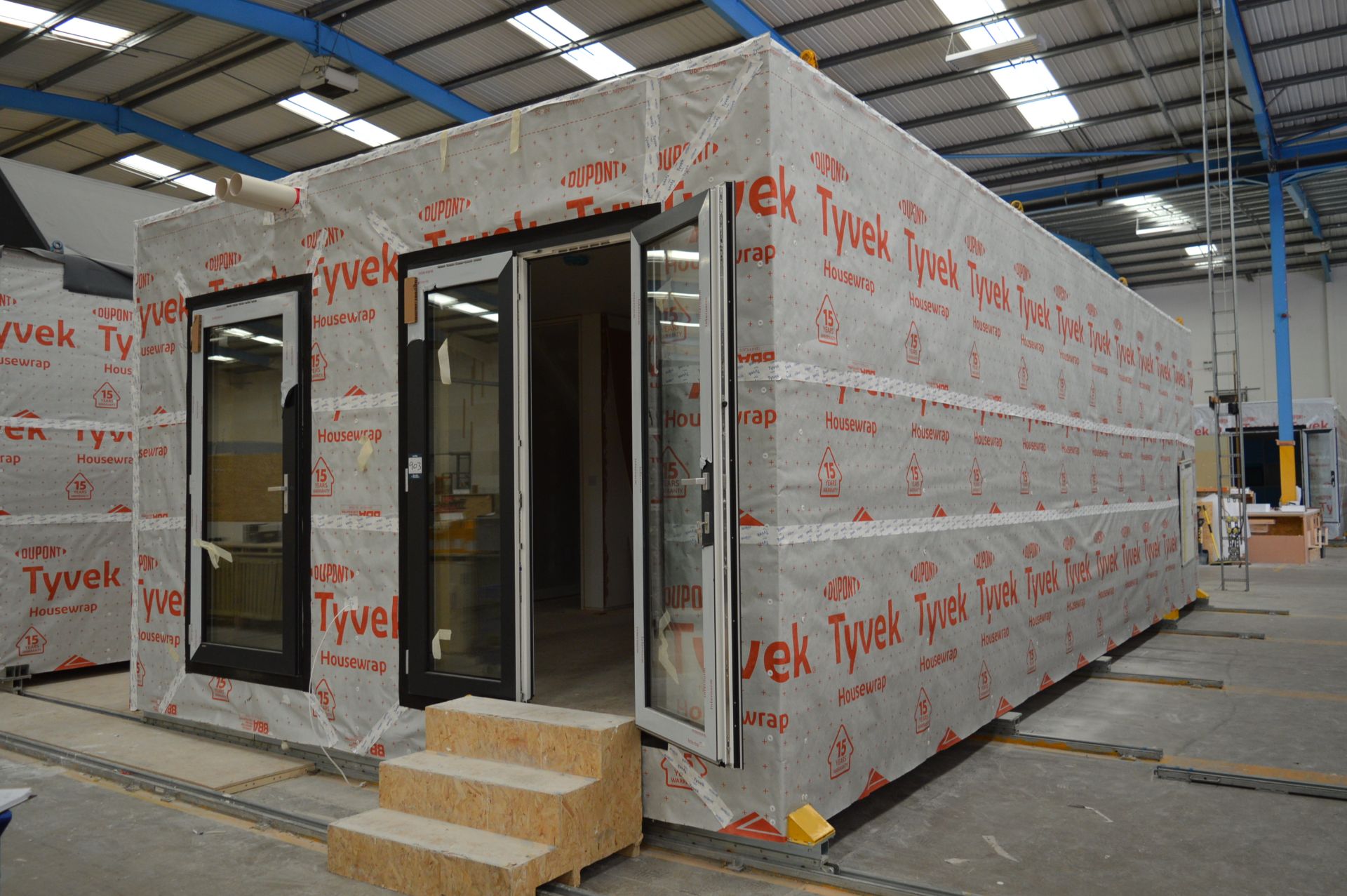 Housing pod with part fitted kitchen, fitted WC, heaters and staircase, approx. 10.7m x 5.0m x 3.