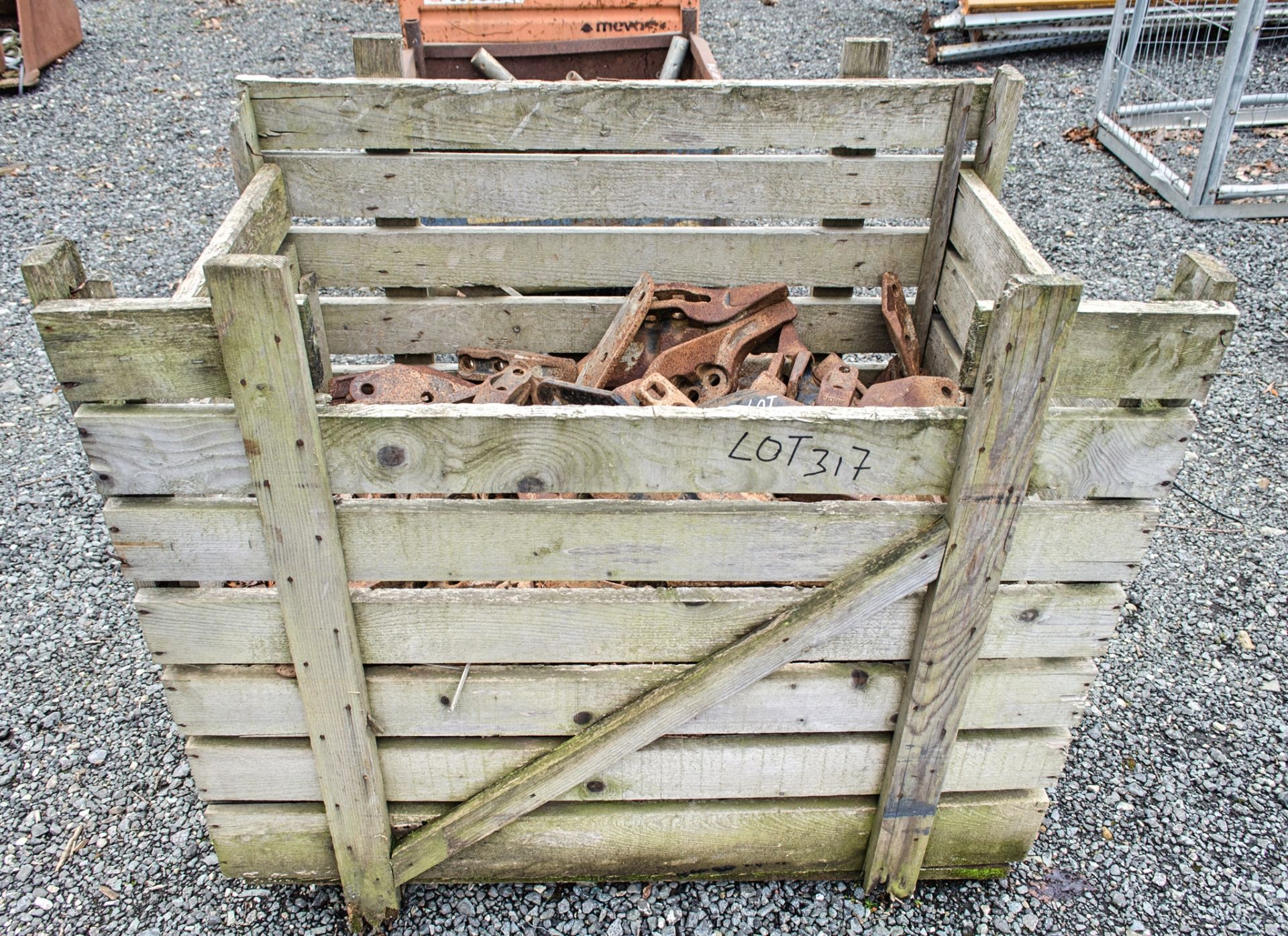 Wooden crate of digger bucket teeth as photographed